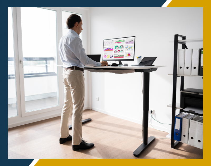 Man at standing desk working on computer